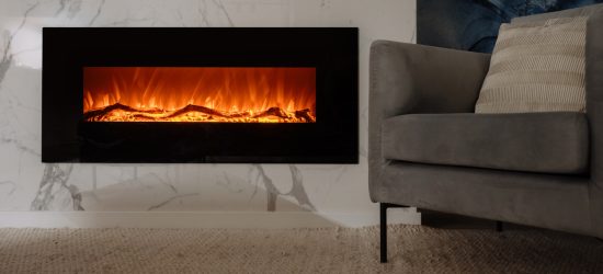 Electric fireplace with flames next to a gray couch in a modern living room.
